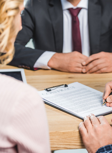 man signing a contract