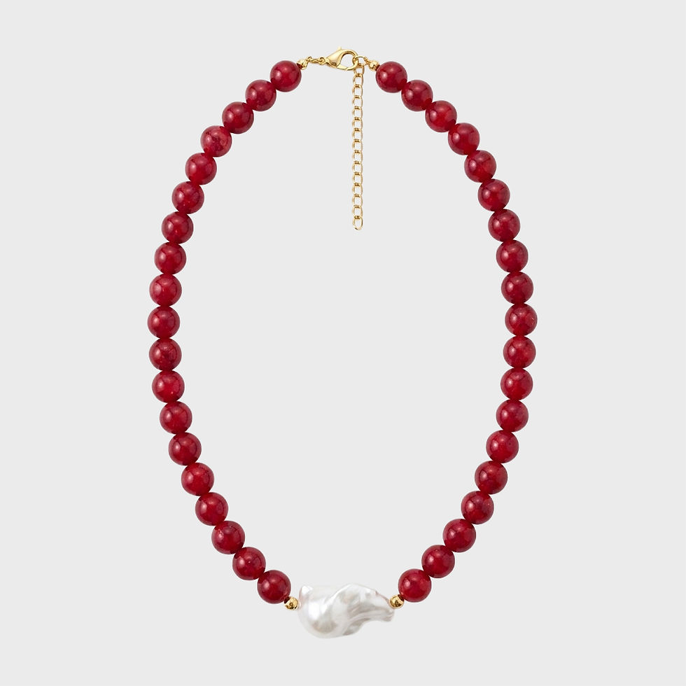 Chunky red gemstone bead necklace featuring a dangling organic baroque pearl charm.