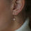 Thumbnail: 14K gold double studs earring on a model