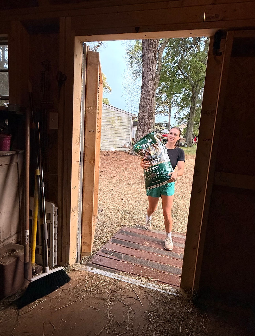 Lauren, unloading goat feed that was donated by a community member.