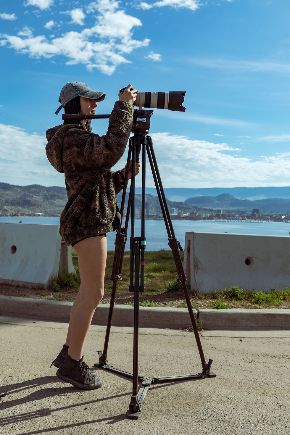 Videographer with camera on tripod