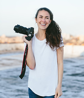 Emily Fletke holding a camera and smiling