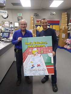 Ship and Copy owner Joe Mandera poses with employee Christian Ty and "That's Ridiculous, Said Nicholas" poster