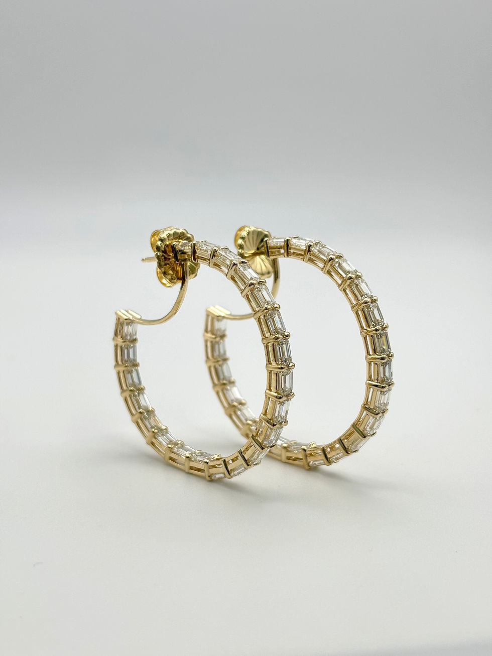 Thumbnail: Classic emerald cut diamond hoop earrings in 14k yellow gold