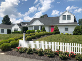 White and Pink house with white fence - After. 
