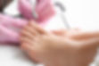 Young woman getting pedicure with milling cutter in beauty salon, closeup.jpg