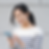 A woman smiles while looking at her cellphone