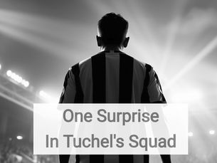 A cinematic, wide-angle shot from behind an England player as they stand on the Wembley turf, facing the vast, illuminated Arch and a capacity crowd. The player is wearing the iconic white Three Lions home shirt, their name and number visible on their back as they look up at the towering stands. The stadium floodlights create a dramatic lens flare, and the atmosphere is captured through a slight motion blur of thousands of waving St. George’s Cross flags in the background. It’s a "hero" shot that emphasizes the scale of international duty and the pride of representing the nation.