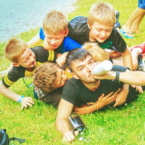 Church camp retreat kids play by camper cabins