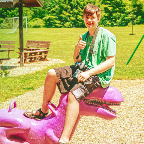 Camp counselor at playground at summer camp