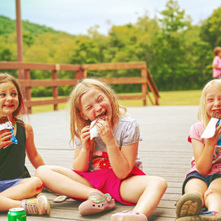 Young girls eat ice cream