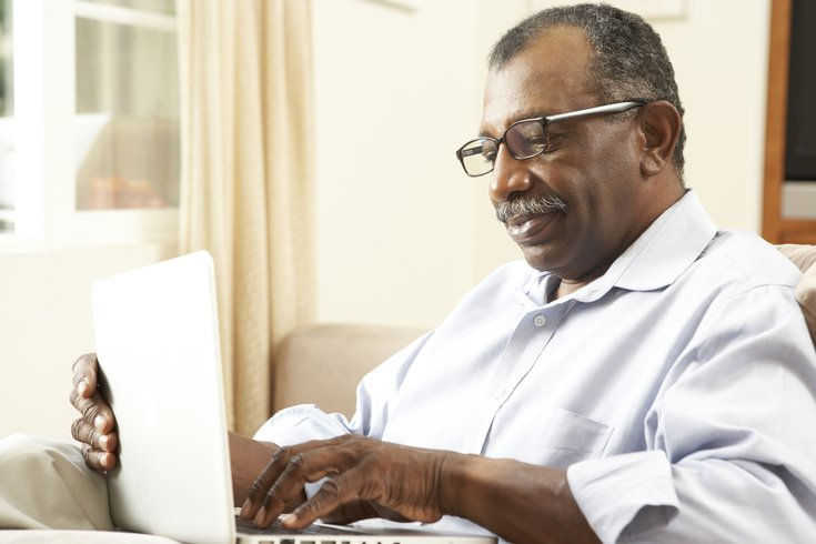 Elderly man using his laptop