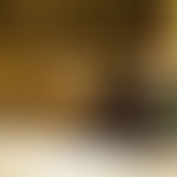 A homeless man sleeping on the pavement covered in snow.