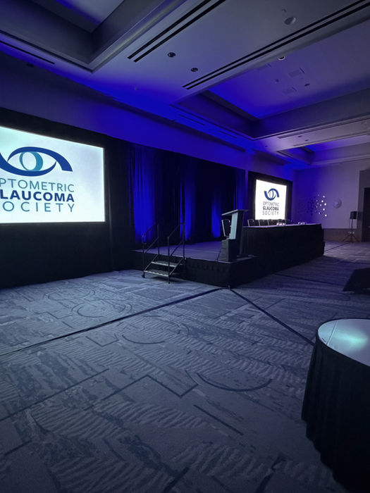 Corporate audio visual CLE program with two large projection screens and projectors.