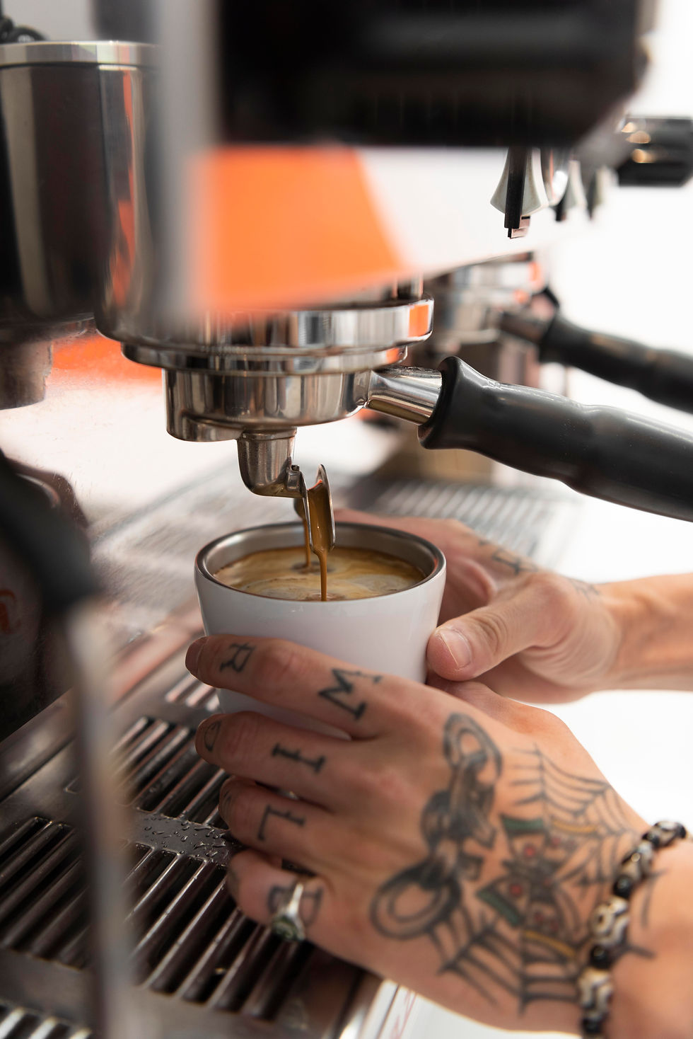 male-barista-with-tattoos-work-using-coffee-machine.jpg