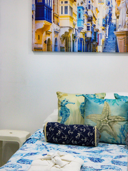 Coastal-themed bedroom with seahorse pillows and city print