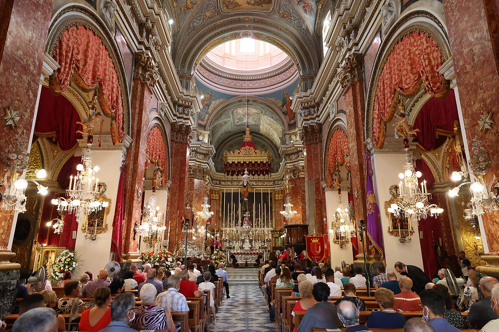 Interior of St Lawrence Church in Birgu Malta during the August San Lawrenz Feast, with traditional red festa drapes and baroque ceiling art