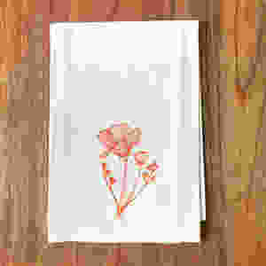California Poppy print in orange on a flour sack tea towel