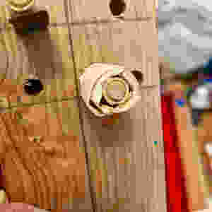 dowel wrapped in tape is part of a squeegee holder for screenprinting dishtowels.