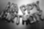 Silver foil balloons spelling HAPPY BIRTHDAY