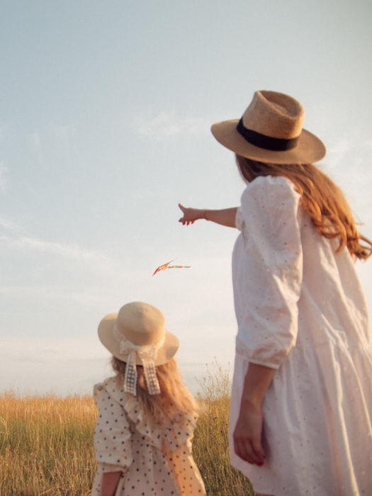 Family looking at a field, woman pointing to the sky