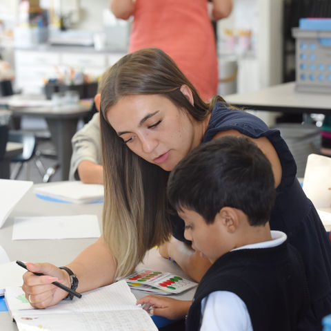 Student working with teacher. 1:1 support. One on one student work with teacher. 1st grade. Personal attention. Small groups. Working with teacher. Personalized instruction.