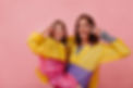 studio-shot-woman-with-little-charming-girl-wearing-raincoats-showing-peace-signs-isolated