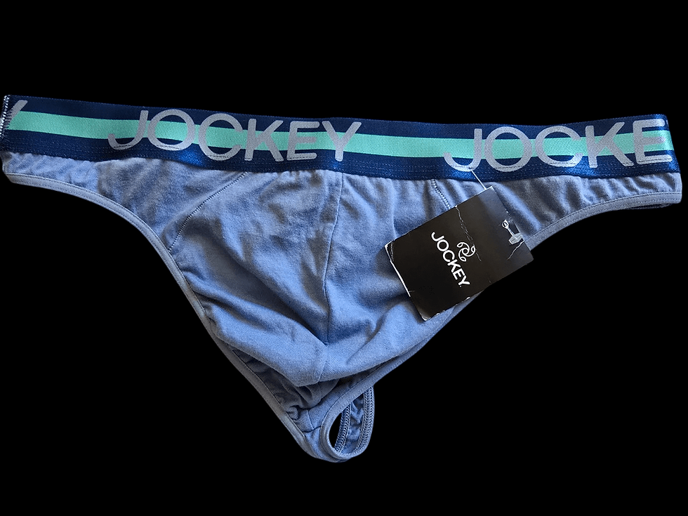 Blue Jockey underwear with a blue and teal waistband, logo visible. Attached is a black tag with Jockey branding. Plain black background.