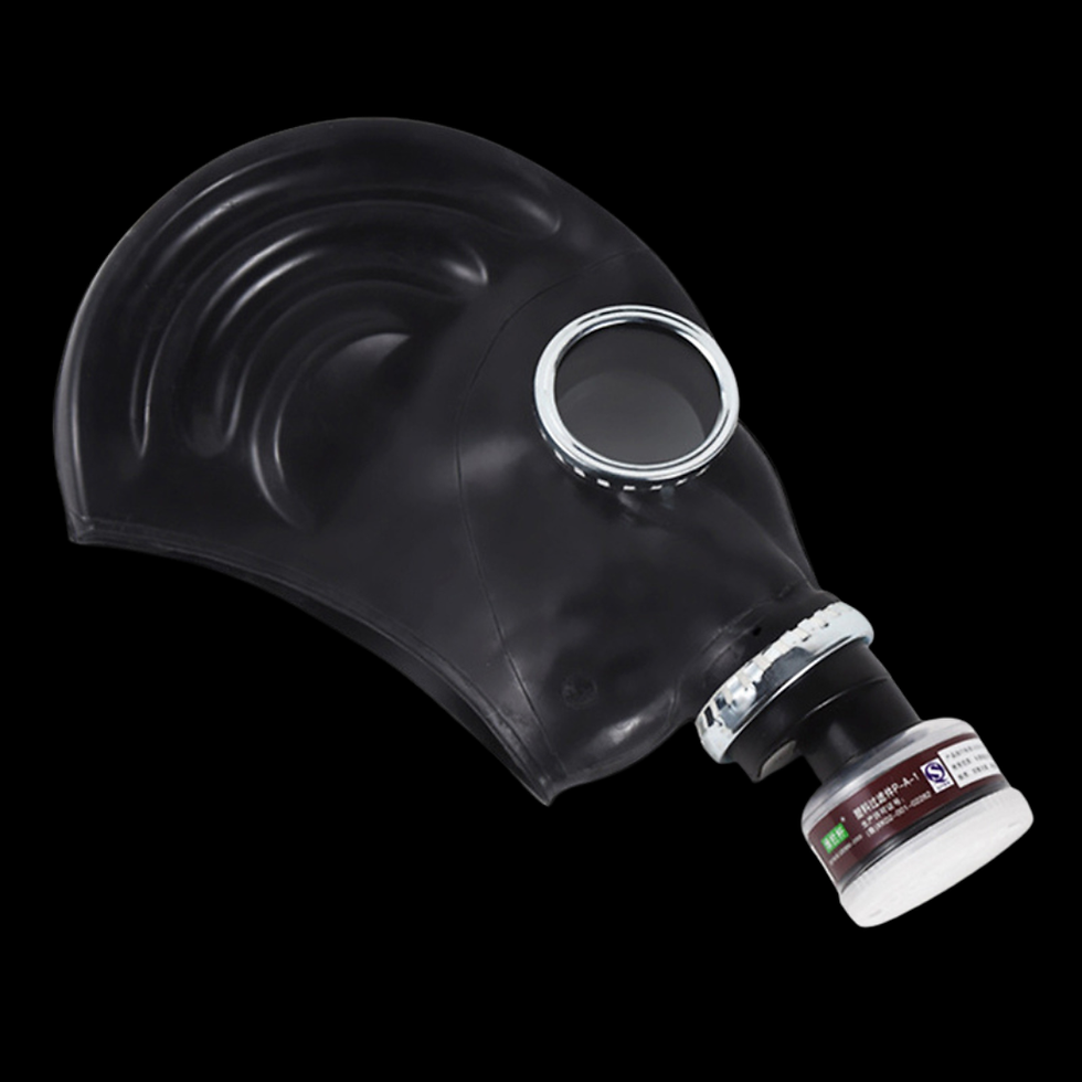 Black gas mask with a filter attached, displayed on a dark background. The mask has a shiny finish and curved patterns.