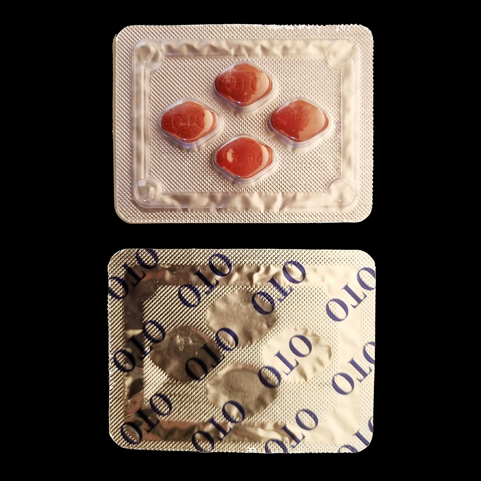 Blister pack of four red pills, top view with clear casing, back side shows text "OLO" repeatedly. Simple black background.