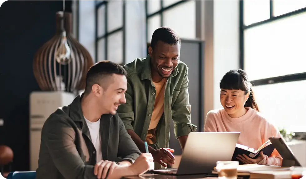 Three people collaborating on a laptop