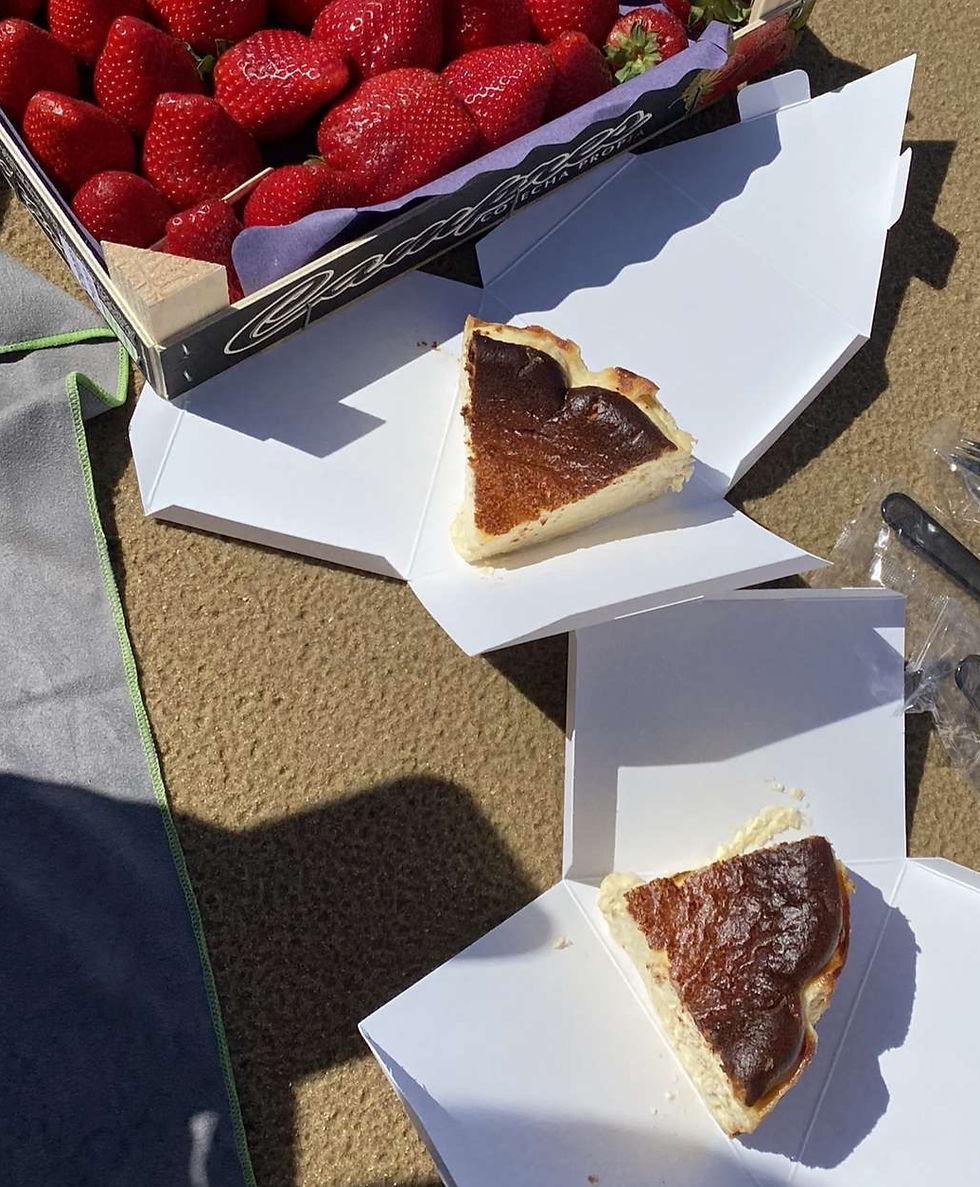 Eating Cheesecake on the beach with a side of strawberries in San Sebastian— what could be better?