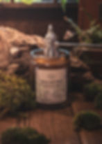 Moss and Mud soy candle being extinguished, earthy woodland fragrance by Wild Nature Candles