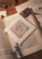 Willow Hall soy wax melts styled on an old book with lavender, amber and lace in a vintage-inspired setting