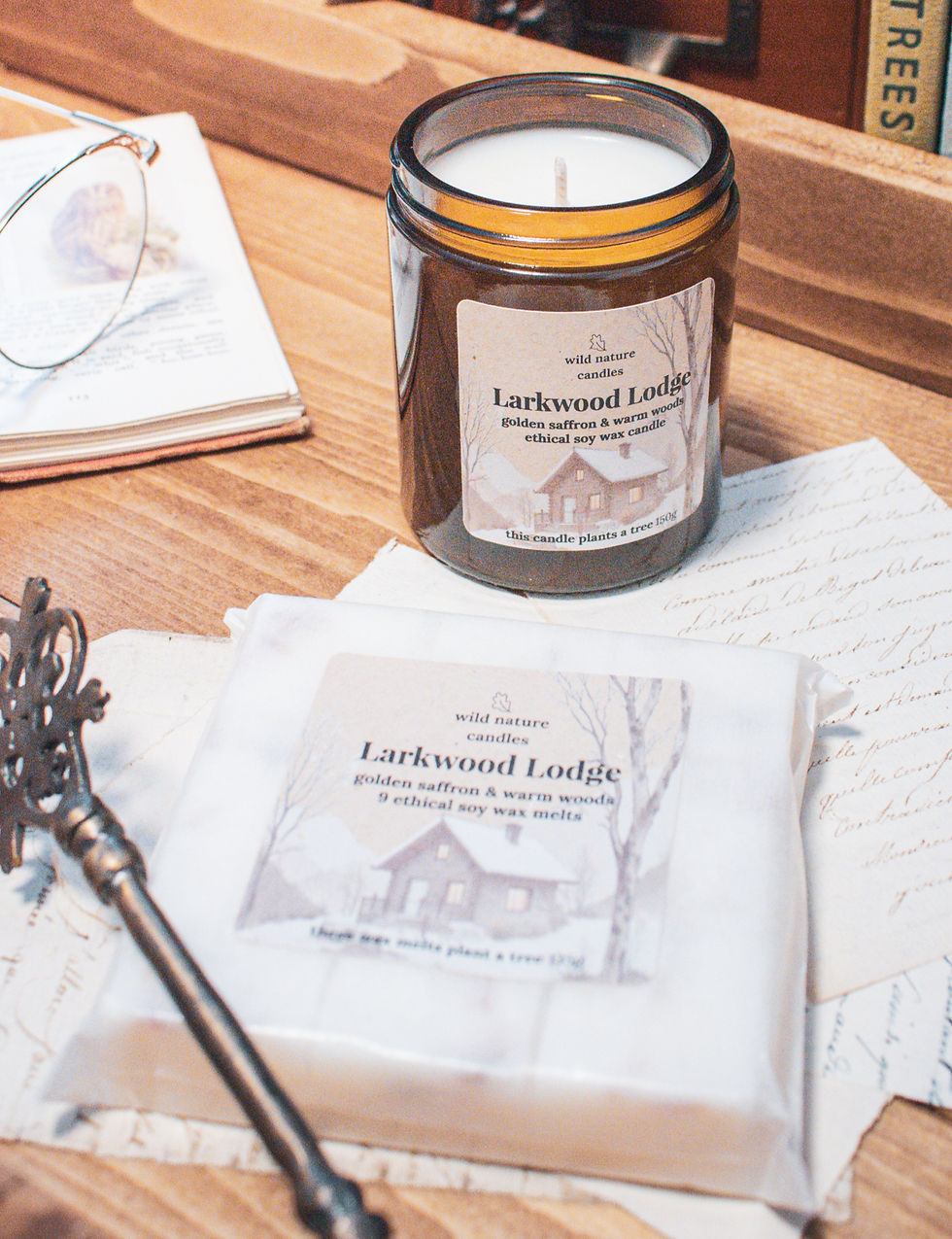 Larkwood Lodge wax melts and matching soy candle styled together on a wooden tray