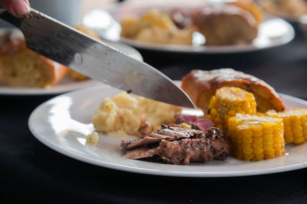 a plate of braai meat and corn