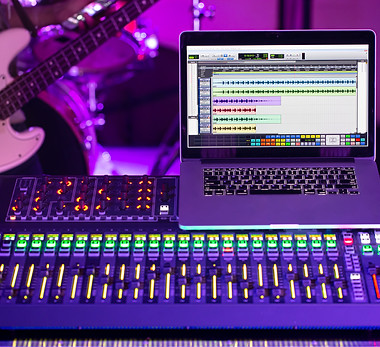 digital-mixer-recording-studio-with-computer-recording-music-background-man-with-bass-guit