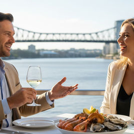 A business meeting taking place at a table with a view of the Brisbane River.
