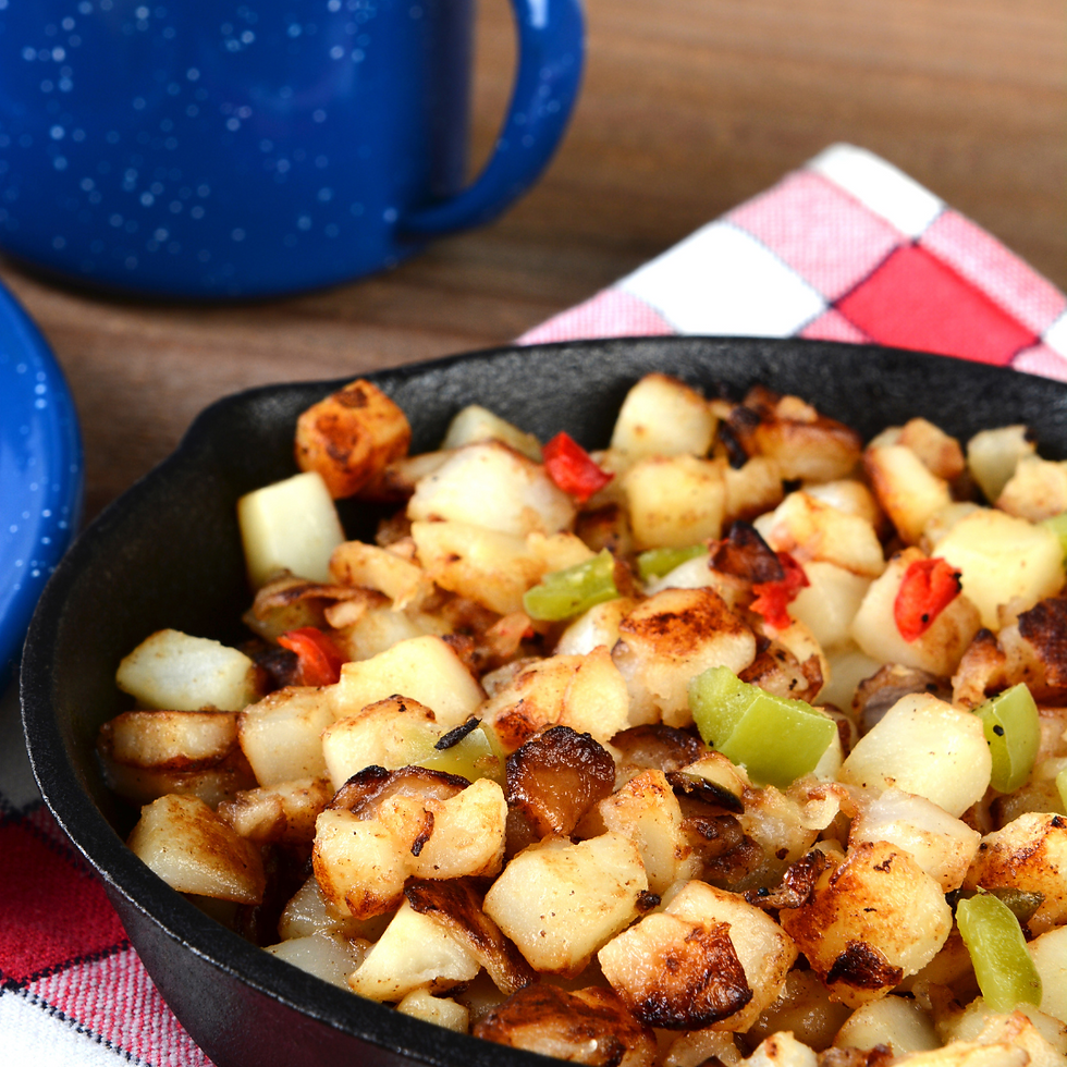 Vegan potato hash with golden-brown potatoes, bell peppers, and onions in a skillet