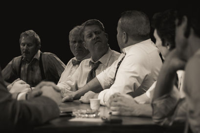 An image from the play 12 Angry Men. Two jurors appear to be speaking to one another.