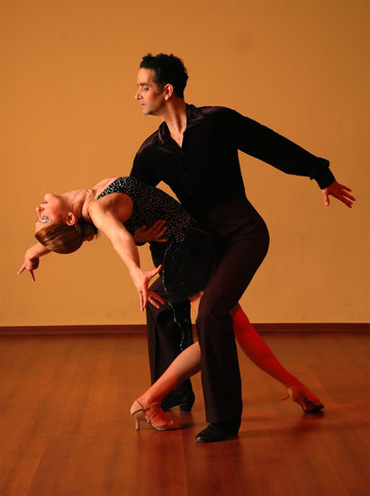 A man dancing with a woman.