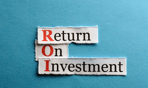Torn paper with "ROI" in red for "Return On Investment" on a blue background. Black text emphasizes concept, creating a business-related mood.