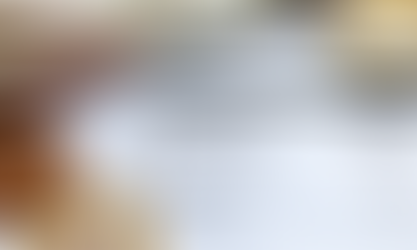 A close-up of a payslip showing gross pay, tax, and national insurance contributions, with British currency notes and coins partially visible.