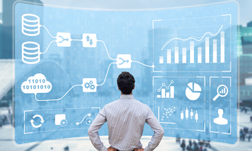 A person looks at a digital analytics dashboard with graphs and flowcharts. The setting is urban with a blurred cityscape. Data-focused mood.