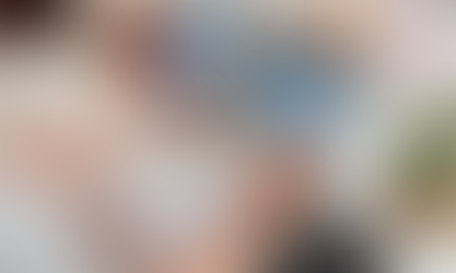     Managing finances efficiently: a person checks their online banking on a smartphone while analyzing bills on a tablet, with a notepad and calculator nearby.