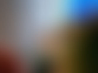 A worship leader in a tan shirt raising their hand in praise