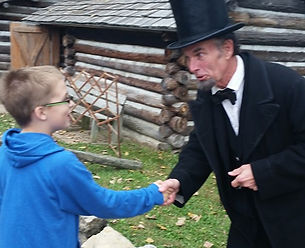 Young Sam shakes hands with a Man Portraying Abraham Lincoln