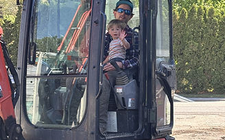 Man holding child in excavator