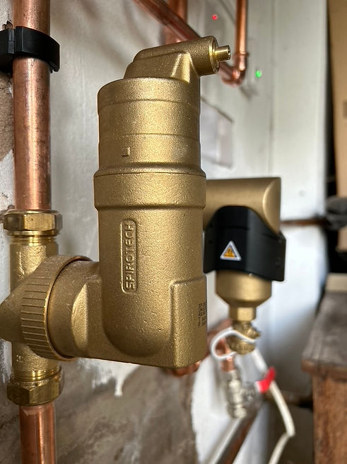 Lombardi Heating image of an air separator and system filter on a boiler install