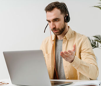man-with-headset-having-video-call-laptop.jpg